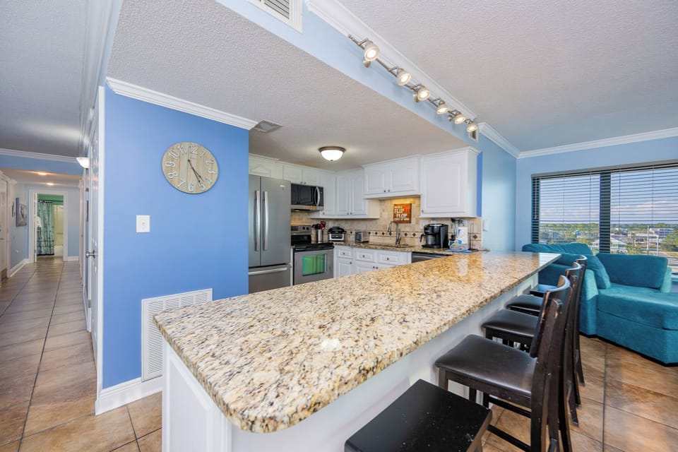 Gather around the granite counter to share laughs while whipping up beachside snacks in the inviting kitchen space