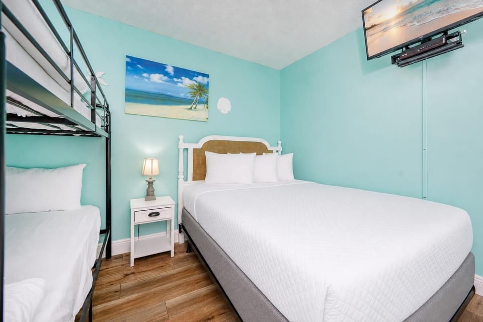 Feel at home in this cheerful bedroom, where a cozy queen bed invites restful nights and playful bunk beds spark family fun