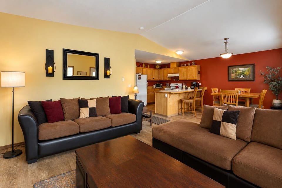 Living Room with sectional, gas fireplace, in wall AC unit, and TV with Streaming Apps.