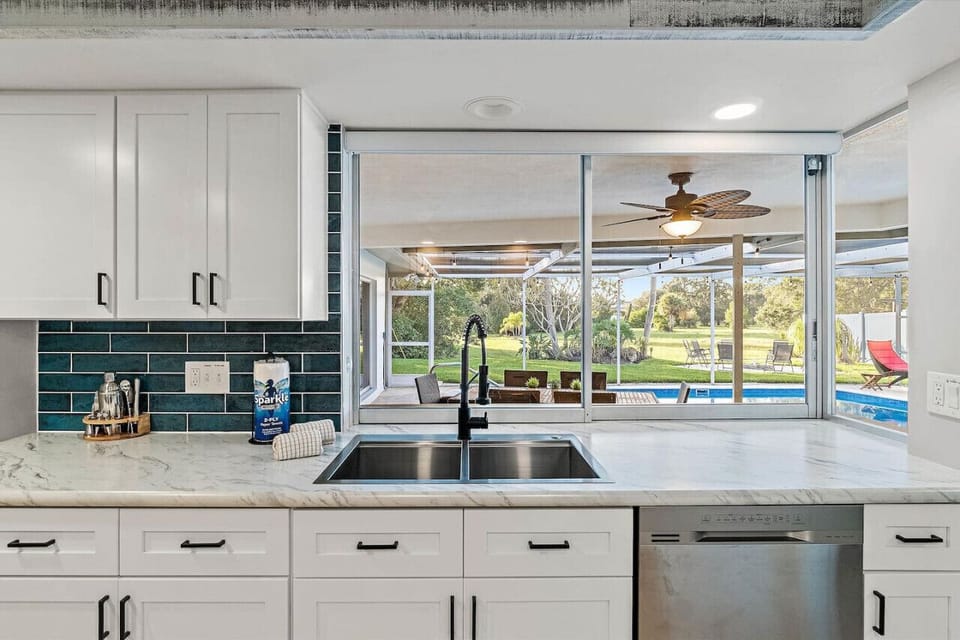 Open the oversized sliding window to the outdoor bar and pool.