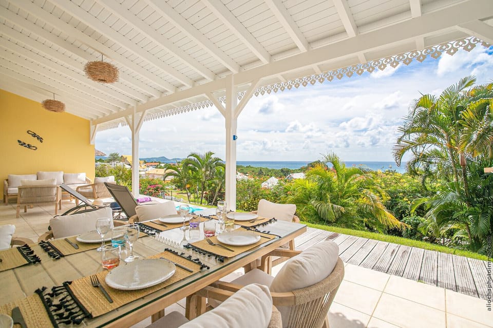 A beautiful sea view terrace beautifully decorated with a living and dining area to enjoy the mild climate of Martinique.
