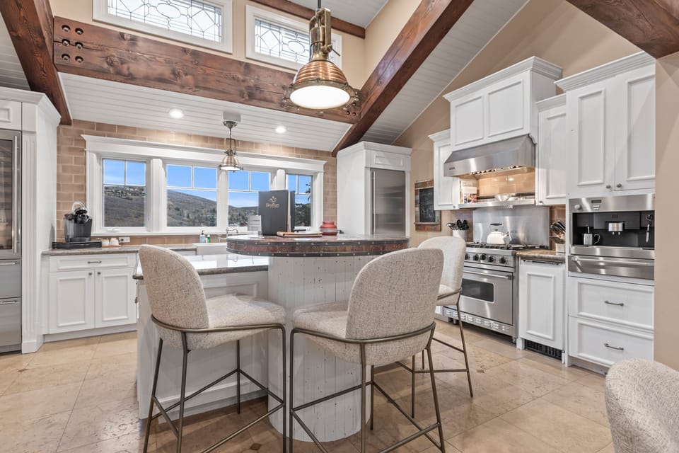 Cook in style in our fully-equipped, modern kitchen with mountain views, high-end appliances, and a cozy island.