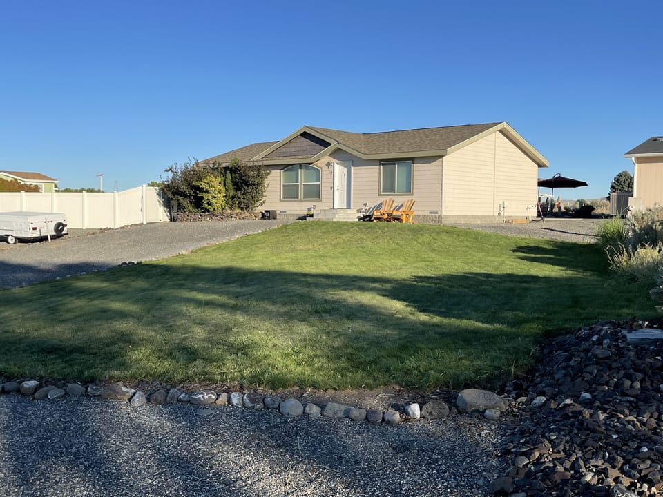 Front of house with large grassy area for games.