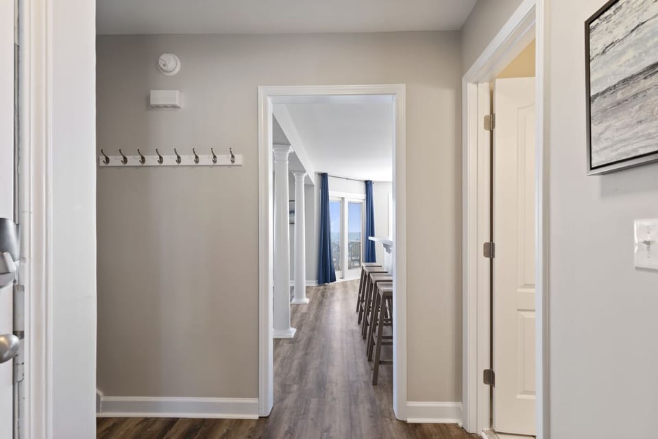Entry hall between the kitchen, living room, bathroom, and main level bedroom.