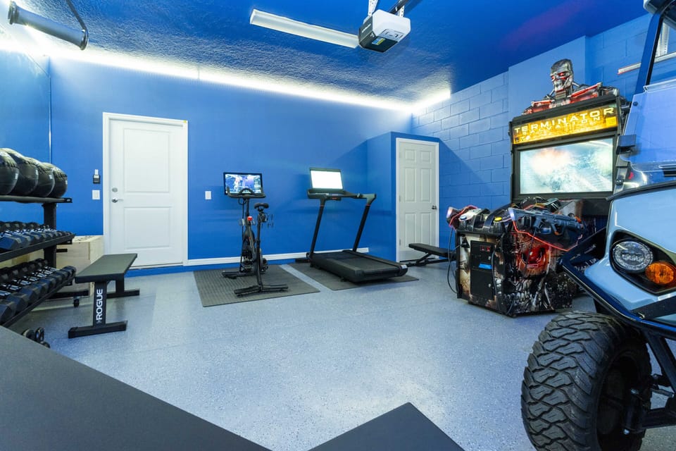 Converted garage showing arcade games with Peloton bikes.