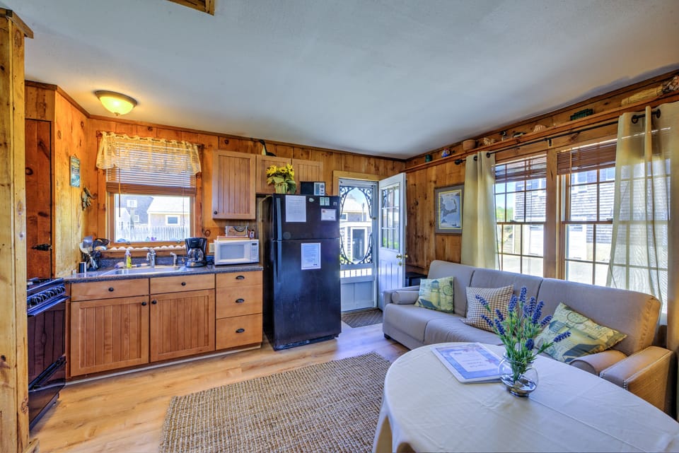 Open concept living with sleeper sofa /dining/kitchen area.