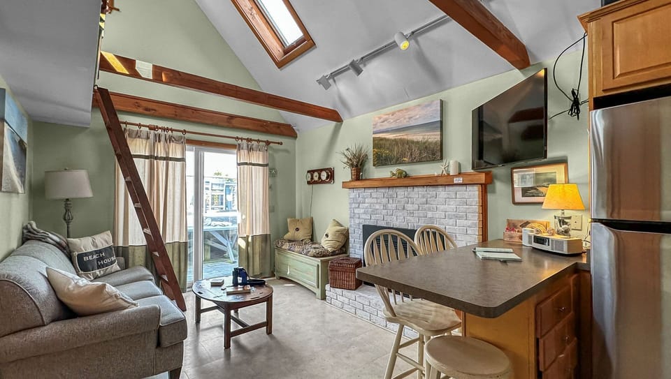 Kitchen/living room with seating for four guests at the island.