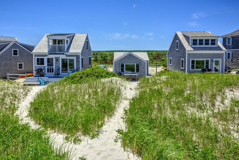 Back of the home with private walkway to the beach.
