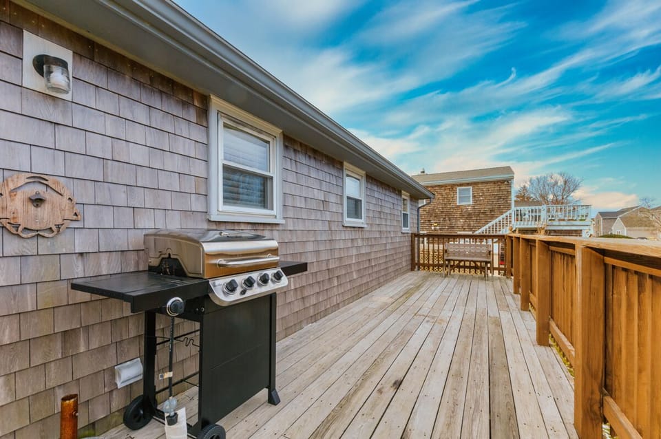Spacious back deck with grill for family gatherings.