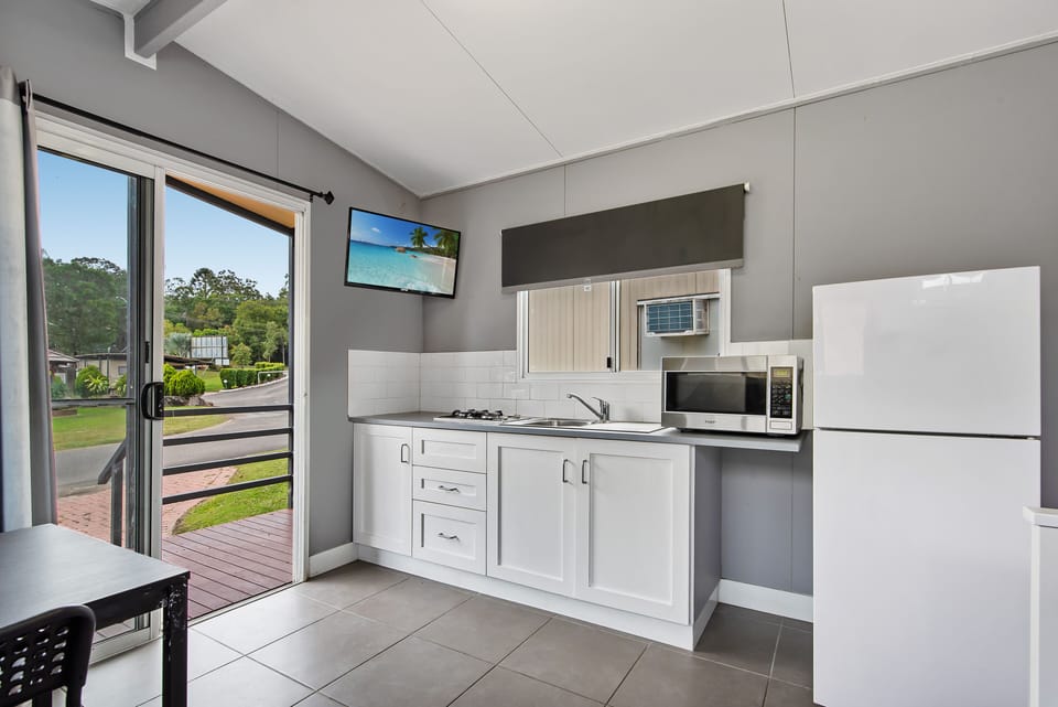 Deluxe Cabin | Private kitchen | Microwave, electric kettle, toaster, dining table