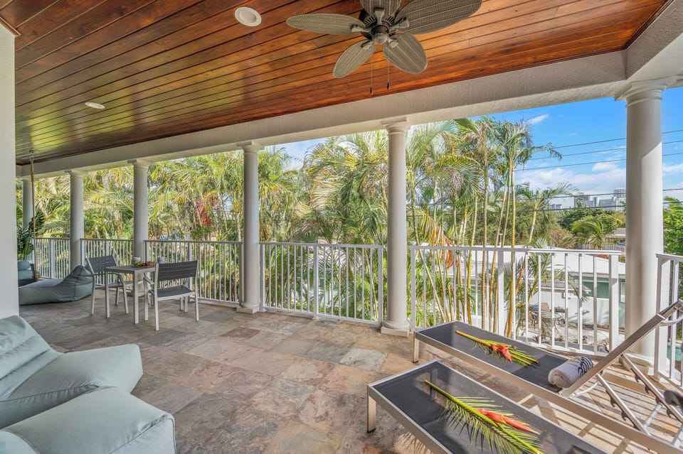 The veranda overlooks the heated pool and has its own private queen hanging bed by Nate and Lane.