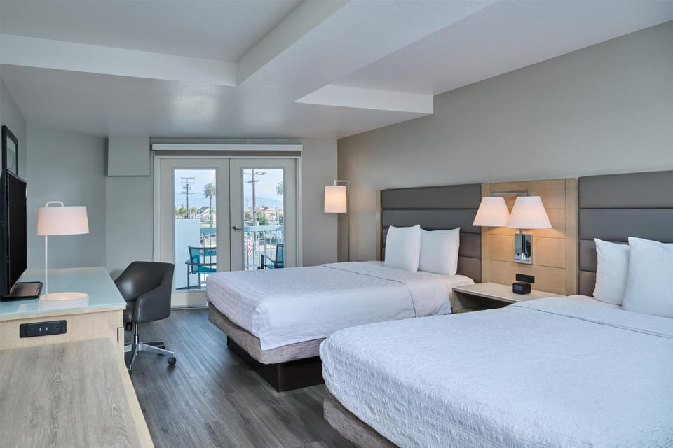 Room, 2 Queen Beds, Balcony | In-room safe, desk, iron/ironing board, free cribs/infant beds
