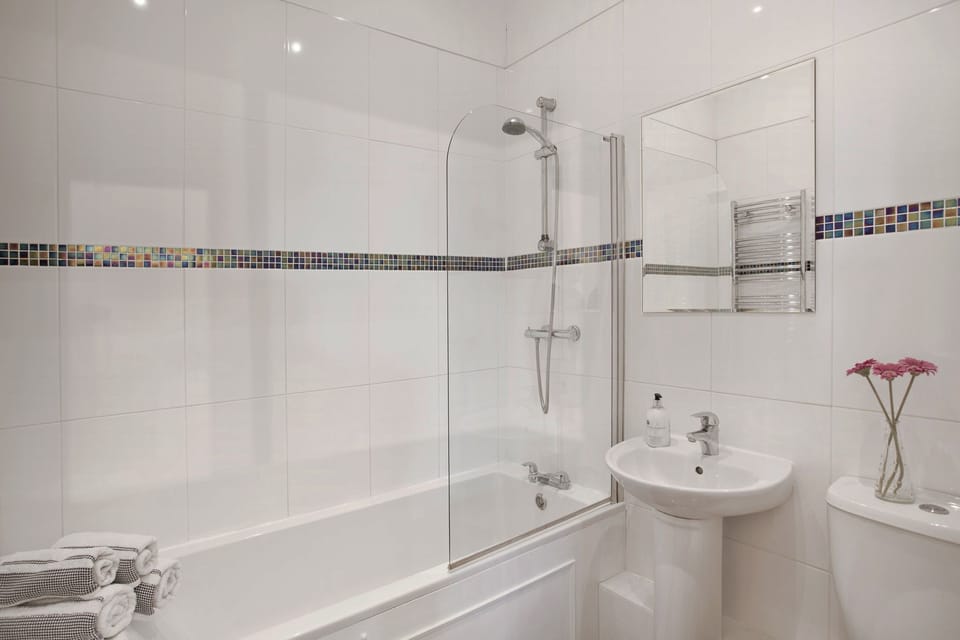 Bathroom with shower over the bath at King size bedroom with wonderful views at Burnside View in Hawes, Wensleydale in the Yorkshire Dales