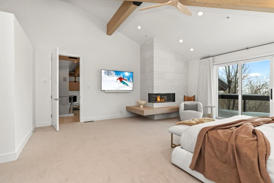 Wake up to treetop views in your luxurious primary suite with King bed and built-in TV.