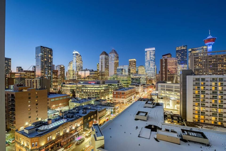 Private balcony with outdoor seating, a smoker/grill, and epic views of the Calgary tower.