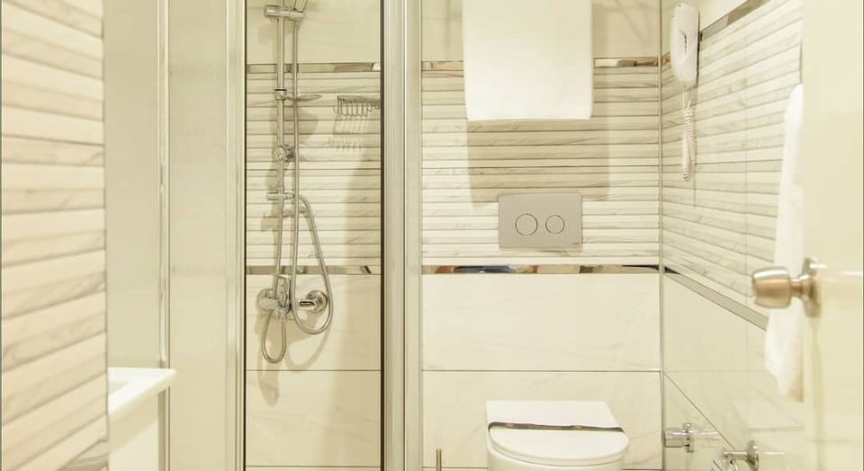 Shower, rainfall showerhead, slippers, towels
