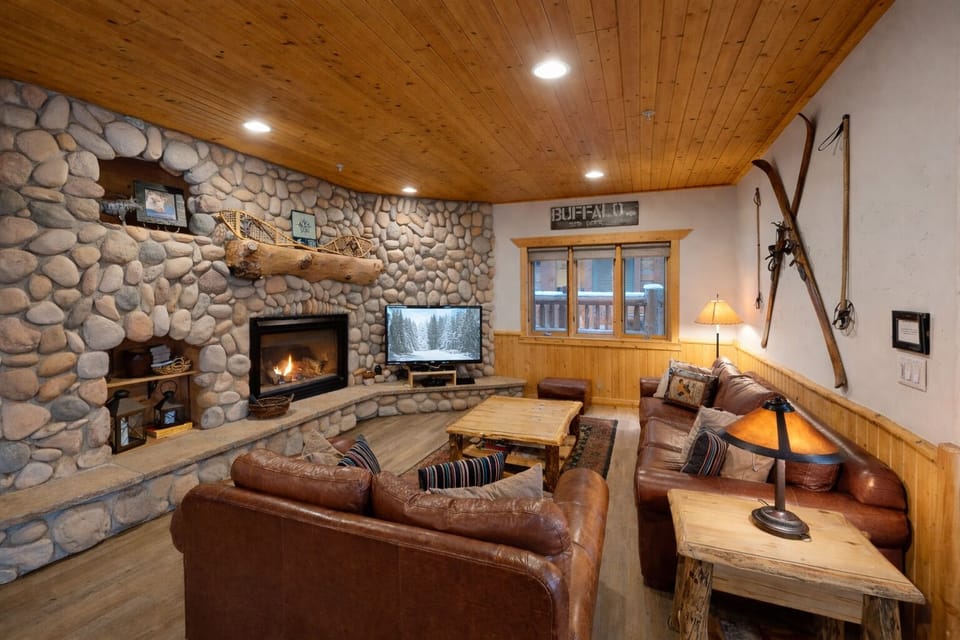 Cozy up by the crackling stone fireplace with your favorite show, surrounded by rustic charm and leather comfort.