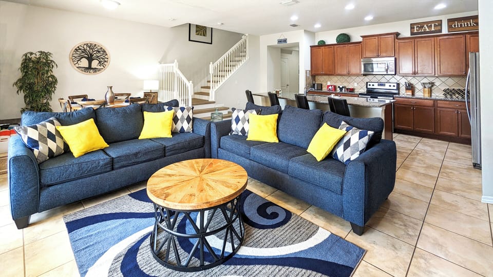Open-concept spacious main living room, dining room, and kitchen with island.