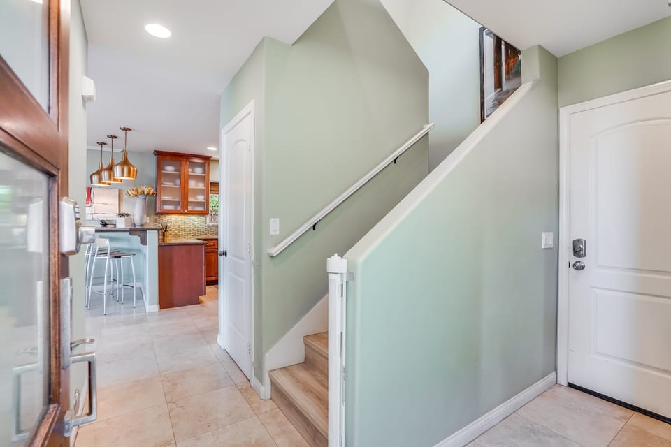 Access the upper floor directly via this hallway located just off the entrance.