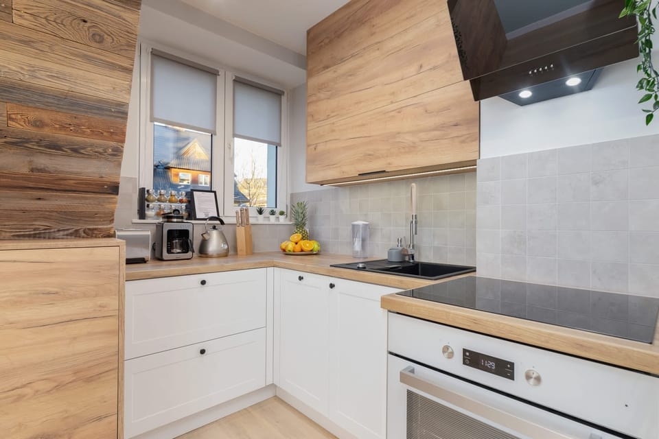 Kitchenette with oven and refrigerator. 