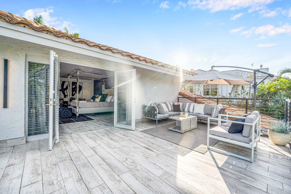 Balcony lounge area with stair access to the pool and waterway off the primary bedroom.
