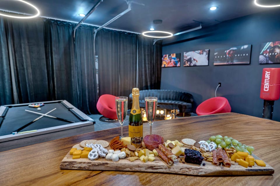 Game room with pool table, bar area, large flat screen TV.
