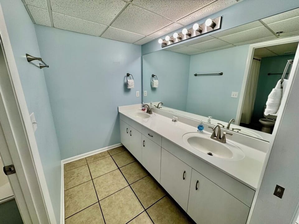 King bedroom private full bath with shower / tub combo and double sinks