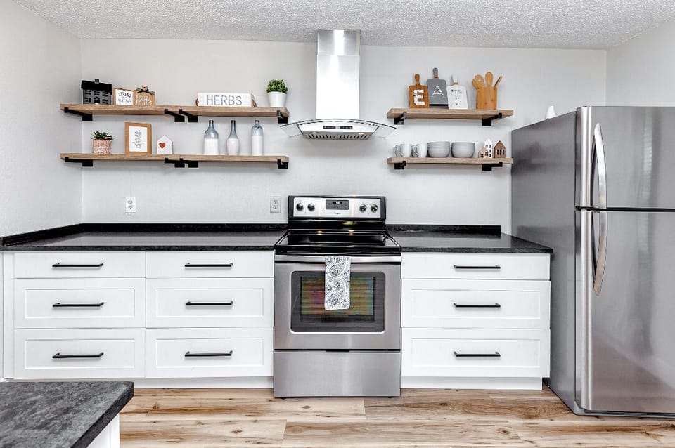 Modern kitchen with top-notch appliances, perfect for cooking or quick bites.