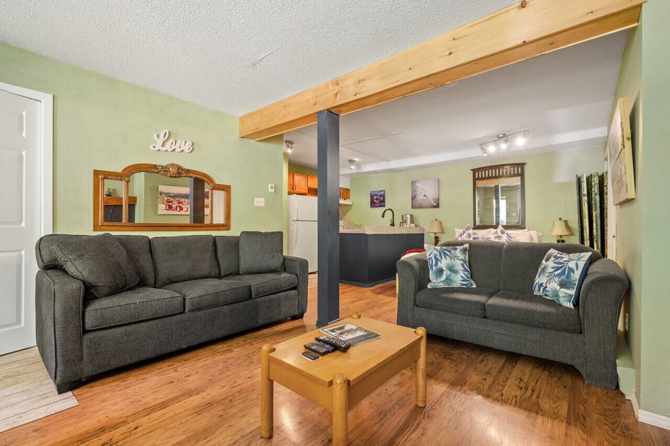 Living room with a smart TV with cable, cozy seating, pull-out sofa bed & a decorative fireplace (glow logs only!)