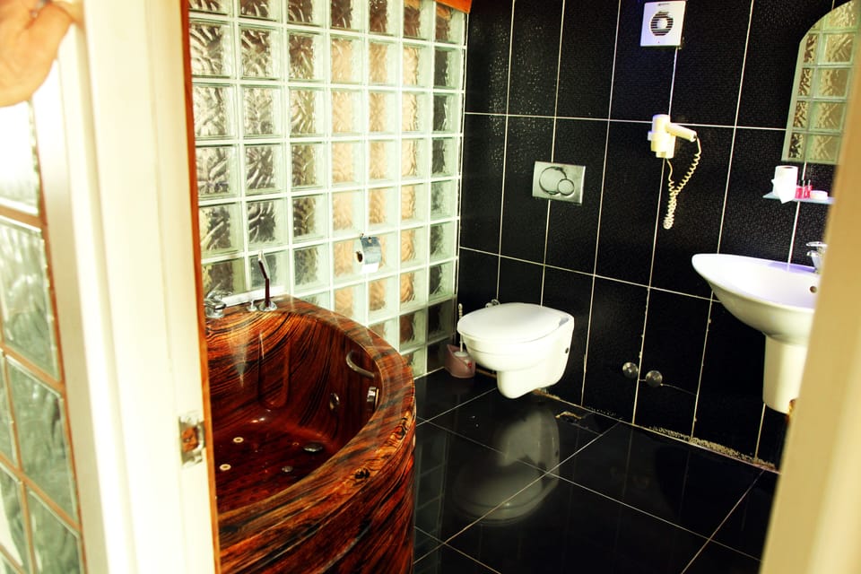 Classic Studio Suite, 2 Double Beds, Smoking, Sea View | Bathroom | Shower, slippers, towels
