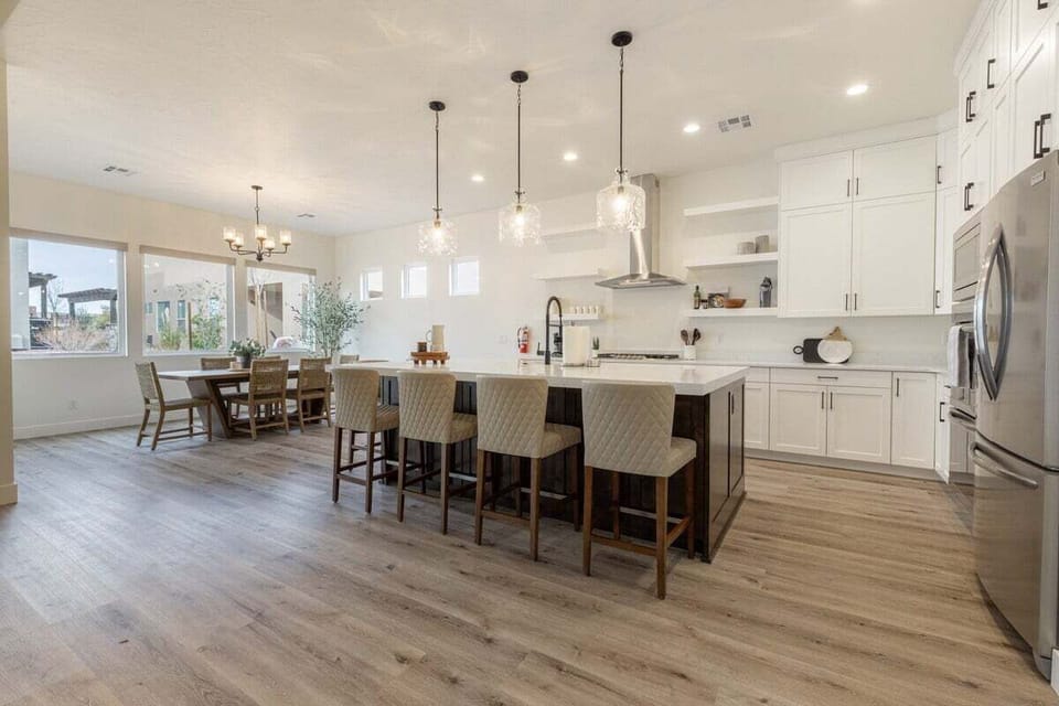The kitchen features sleek cabinetry and a spacious island for prep work, ensuring functionality and style. Equipped with ample counter space, smart technology, and necessary utensils it's designed for both casual cooking and gourmet meals.