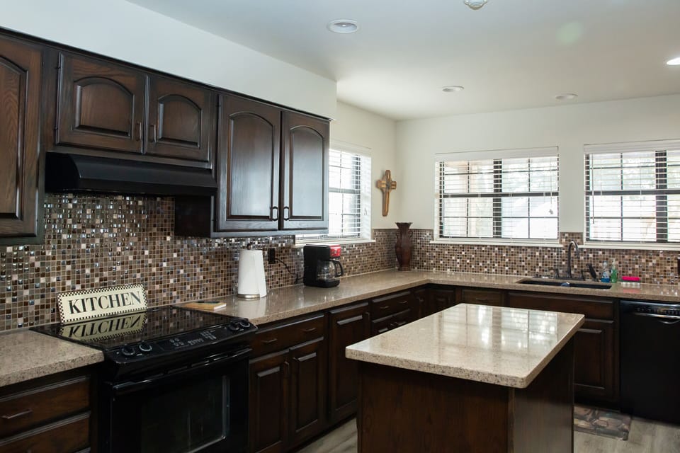 Full kitchen with stove, oven, dishwasher and refrigerator.