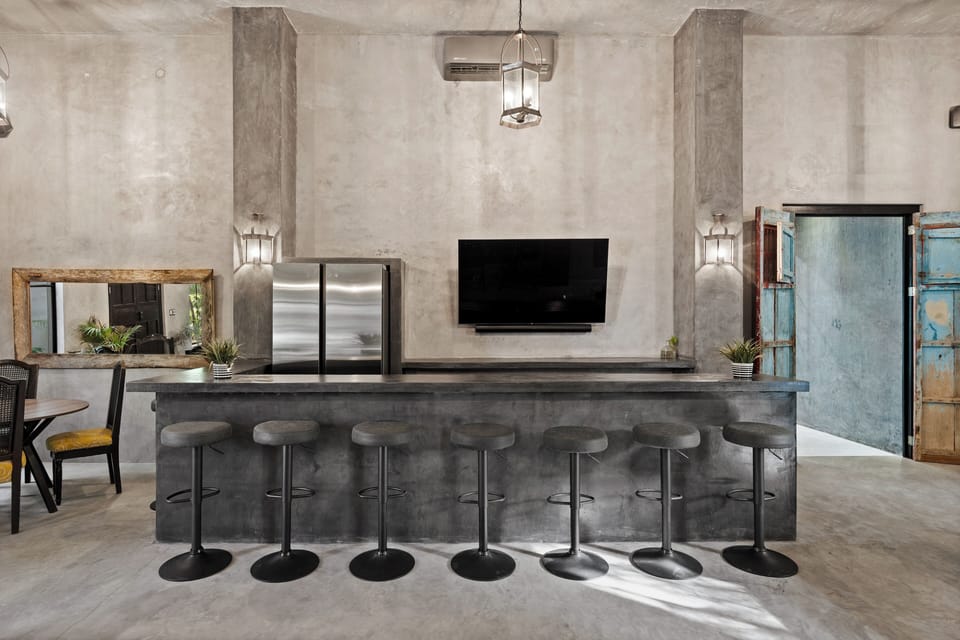 Custom built full-sized bar with fridge/freezer and 60" smart TV