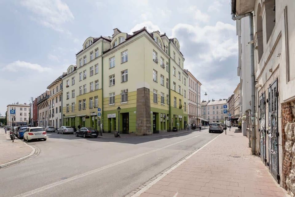 An exterior view of a historic building with classic architectural details, located on a charming street with a vibrant urban atmosphere.






