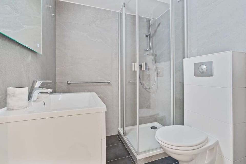 Elegant bathroom featuring modern amenities and a spacious shower.