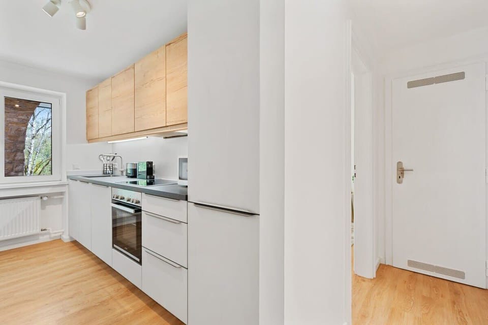 Modern kitchen with clean lines and high-end appliances, perfect for home cooking.