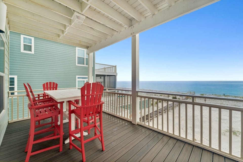 Main level deck, directly facing the gulf, with dining and seating space.