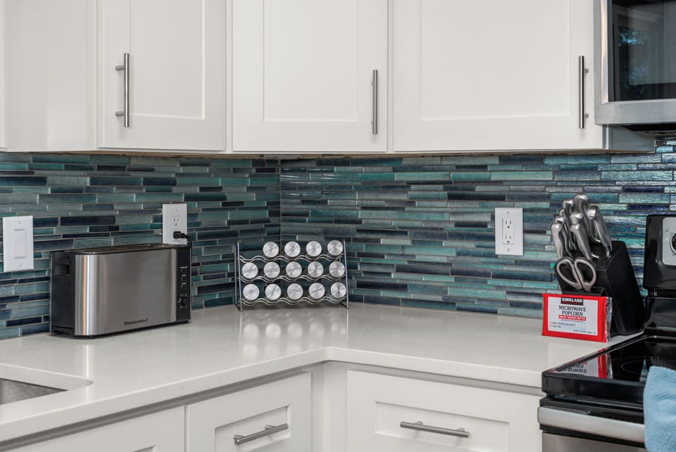 Modern kitchen with bold blue backsplash and clean, guest-ready finishes