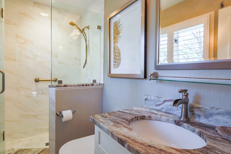 The king en suite bathroom features a spacious vanity and tiled, walk-in shower.
