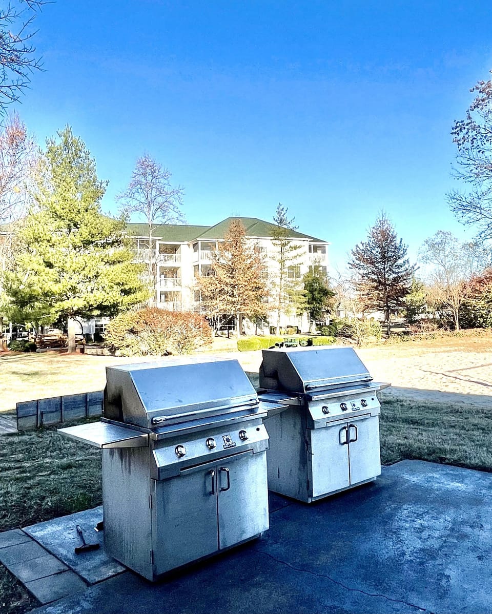 Outside grill area with table and chairs 
