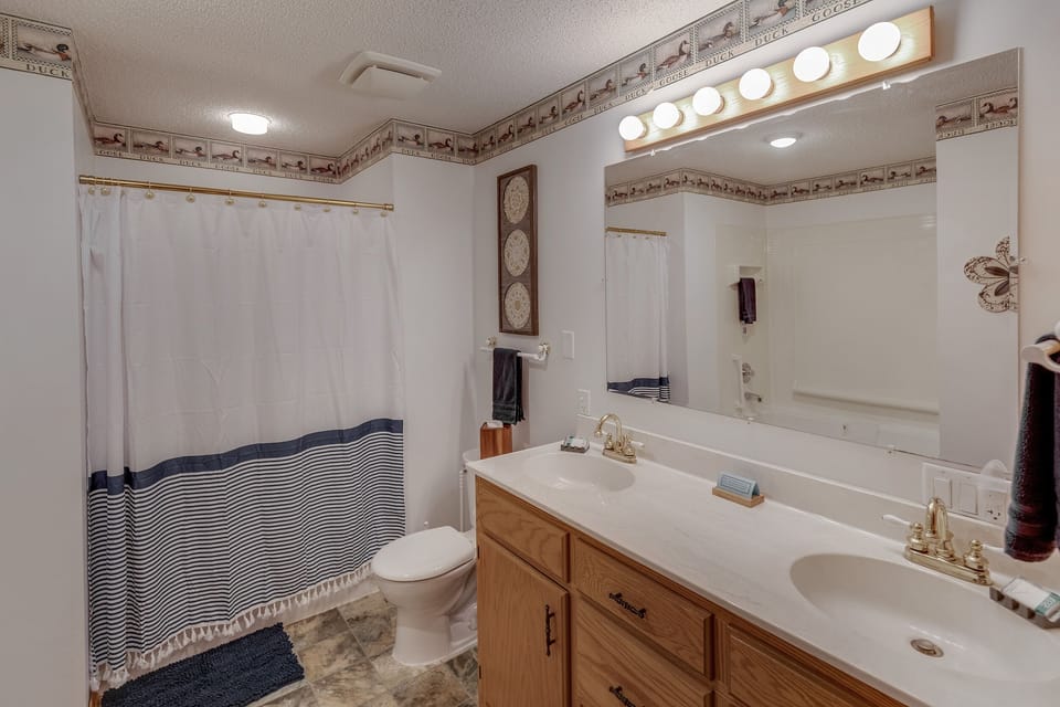 Upper level full bath with double vanity, walk-in shower, and jetted tub, and toiletries included