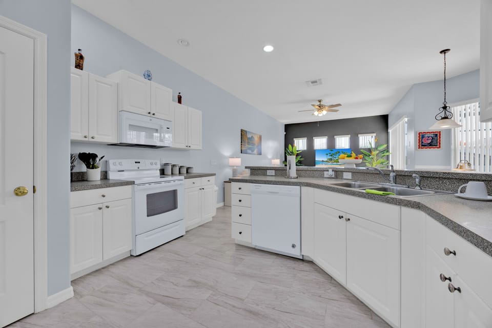 Enjoy a fully stocked kitchen with full sized appliances and plenty of seating