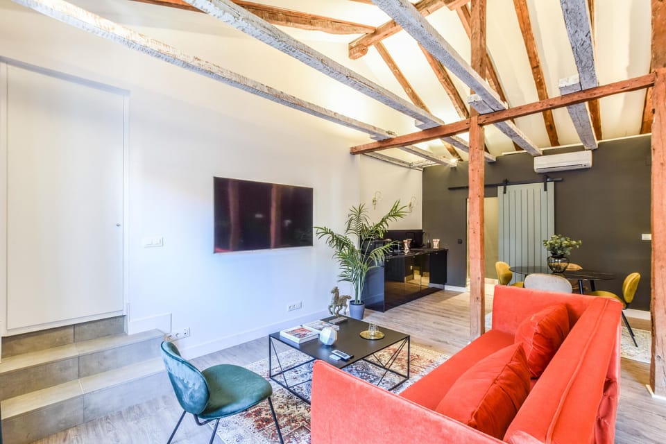 View of the living room area with sofa and Smart TV