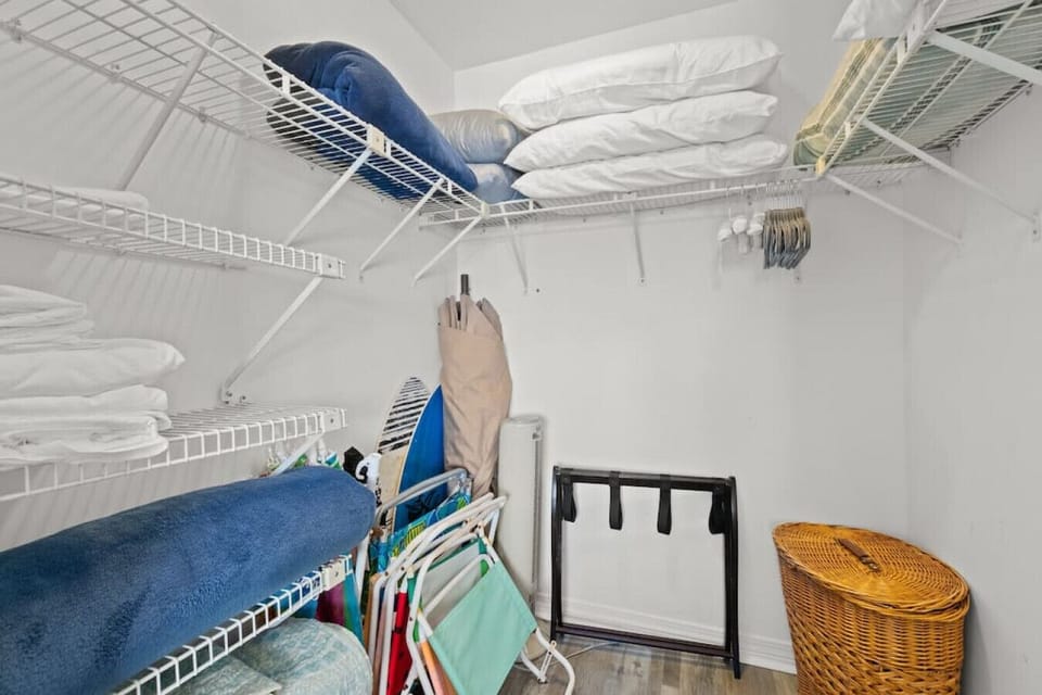 King room walk-in closet, with luggage rack & beach gear, spare linens