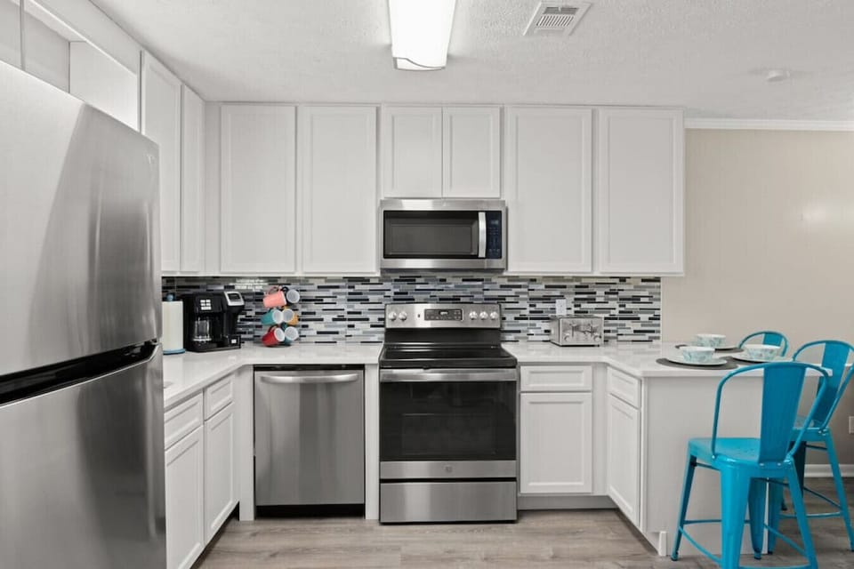 Fully updated kitchen with stainless steel appliances, a breakfast bar for 3, and everything you need for a comfortable stay.