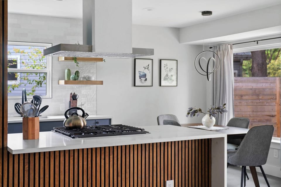 Modern island with sleek wood accents and a stylish hood — a perfect blend of function and design