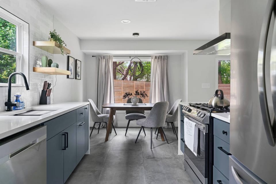 Modern kitchen with plenty of counter space, open shelving, and a welcoming dining nook