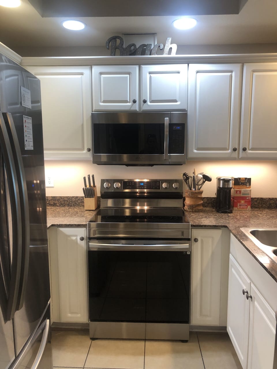 Kitchen has granite countertops and high end stainless steel appliances.