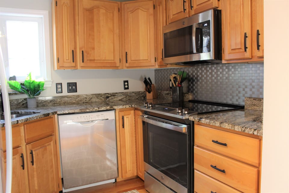 Cozy kitchen with electric stove | range, dishwasher, microwave and refrigerator