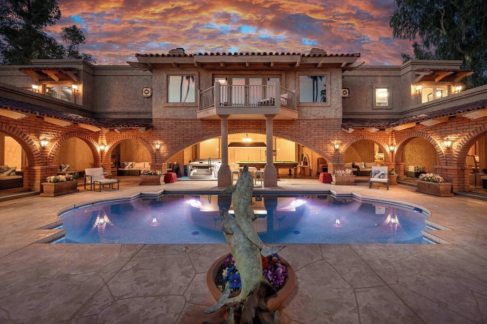 Seven person Jacuzzi and snooker table that is three times bigger than a pool table in a lighted courtyard with 52 light fixtures, heated LED lit Roman pool and Grecian columns.